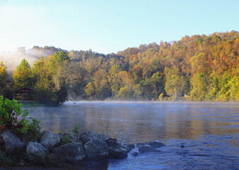 Wall Mural - Looking down the White River in Cotter, Arkansas as the early morning fog is lifting and the sun is starting to shine 