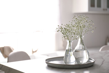 Wall Mural - Vases with gypsophila flowers on table in kitchen, space for text. Interior design