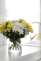 Wall Mural - Vase with beautiful chrysanthemum flowers on countertop in kitchen. Interior design