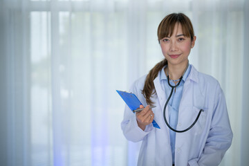 Smiling female doctor in white coat with  Medical stethoscope and Patient prescription . Portrait beautiful young Asian Medical physician doctor.