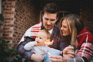 Wall Mural - Family Celebrating at Home with Sparklers