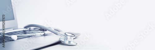 Stethoscope on a laptop. Virus season, pandemic. Remote medicine or elearning and telemedicine and consultation advice. Copy space. Medical network or contact us banner