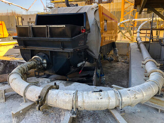 Concrete pump with pipeline.Concrete pumping, distributing and placing equipment