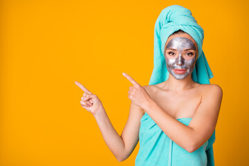 Wall Mural - Photo of attractive young lady show point finger empty space advert recommendation spa treatment isolated over yellow color background