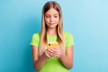 Sticker - Photo of young serious charming lovely pretty girl using cellphone browsing internet isolated on blue color background