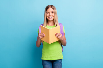 Sticker - Photo of young happy positive good mood girl reding book wear purple rucksack isolated on blue color background