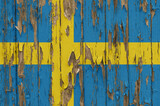 Fototapeta  - Flag of Sweden on a weathered wooden wall