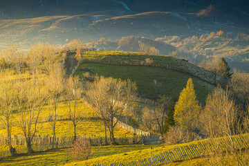 Sunset over the forests and villages from Doftana Valley in Romania at the bottom of Baiului Mountains in autumn landscape after a freezing day