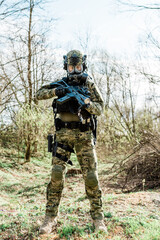 Croatian soldier in Cropat woodland uniform wearing gas mask M95 and assault rifle G36.