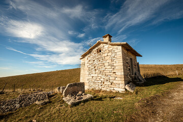 Small stone farmhouse and pastures in autumn on Lessinia Plateau (Altopiano della Lessinia), Regional Natural Park, Verona Province, Veneto, Italy, Europe.