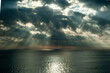 © Pau - A great ray of sun breaks through the clouds and hits the sea.
