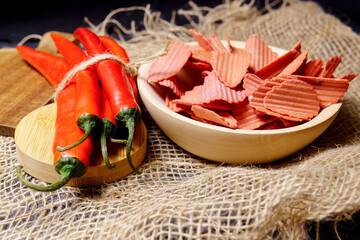 spicy potato chips red hot chili peppers fresh. Unhealthy eating theme. selective focus. rustic style