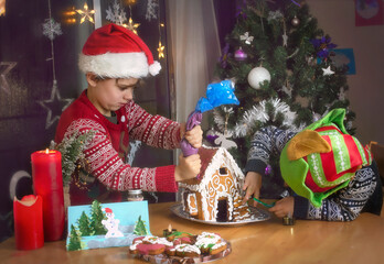 Children decorating  gingerbread house on Christmas