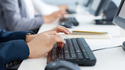 Closeup business people hands typing on keyboard computer desktop for using internet, searching data, working, writing email.