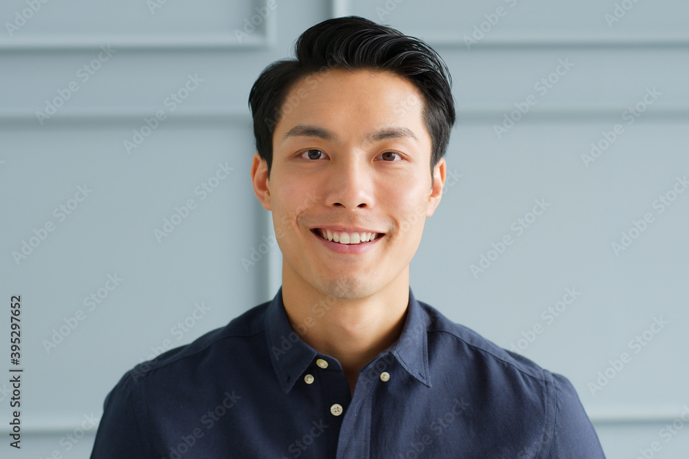 Portrait young confident smart Asian businessman look at camera and smile - obrazy, fototapety, plakaty 