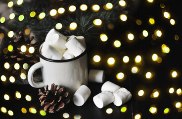 White cup of cacao with a marshmallows on a wooden background