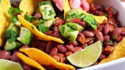 Poster - Bean salad with avocado and nachos in white dish. Mexican food concept.