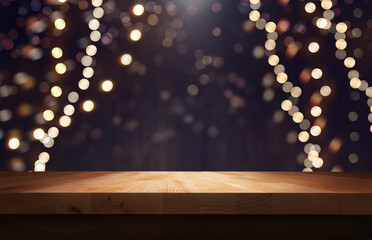 A wood table, tabletop product display  with a festive Christmas background of hanging fairy lights against a dark backdrop.