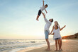 © New Africa - Happy family having fun on sandy beach near sea at sunset