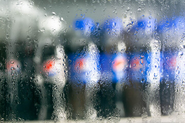 Wall Mural - Blurred image of soft drink bottles on shelves abstract blur background.