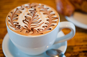 Cappuccino. Fresh cup of dark French roast shot of espresso w/ steamed milk. Classic American. French bistro, coffee house or café beverage. Typical drink served at breakfast. white background