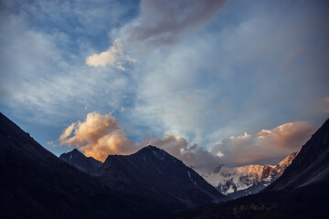 Wall Mural - amazing vivid landscape of sunset with awesome mountain silhouettes and orange clouds. atmospheric h