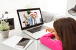 © Angelov - New normal online Christmas celebration. children using laptop to celebrate Christmas with father via video chat, happy holidays, outdoor