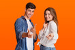 © Prostock-studio - Funny lucky millennial man and woman point fingers at camera and rejoice to success after win at good day