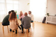 © Monkey Business - People Attending Support Group Meeting For Mental Health Or Dependency Issues In Community Space