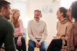 © Monkey Business - Man Speaking At Support Group Meeting For Mental Health Or Dependency Issues In Community Space