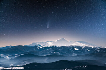 Wall Mural - fantastic winter landscape glowing by star light. dramatic wintry scene with snowy trees and comet i
