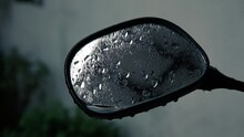 Close Up View Of Wet Motorcycle Side Mirror After The Heavy Rain. Rain Droplet On Bike Side Mirror.