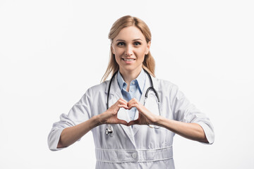 Wall Mural -  nurse in white coat smiling while showing hears sign with hands isolated on white