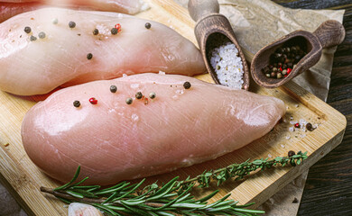 fresh raw farm chicken fillet on a cutting board.