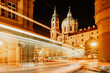 Night view of St. Nicolas Church, Prague, Czech republic. Long exposure city lights.Motion speed scene.Traffic trails in town.City street at night.Transportation travel background.Urban development.