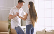© lenetsnikolai - Lovely couple dancing in new empty flat
