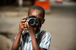 © vystekimages - beautiful little boy holding a camera