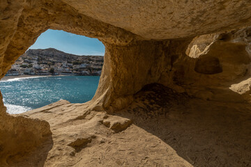 Sticker - Stunning Roman catacombs carved on the sandstone cliffs above the Matala Beach, Crete, Greece. In Roman times, the dead were buried in them, later they were used by the first Christians