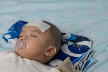 Asian Chinese Baby Sleeping During High Fever With Cool Fever Jel Pad On Forehead