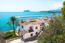 Traditional White Houses With Unspoilt Idyllic View Of Marina, Coastline And Mediterranean Sea In Moraira, Costa Blanca, Spain