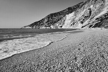 Canvas Print - People resting on the rocky Mitros beach on the island of Kefalonia