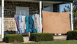 Calico dresses drying on clothesline on front porch of farmhouse
