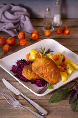 Wall Mural - Roast duck breast fillets with potatoes, carrots, red cabbage and herbs. vertical photo.