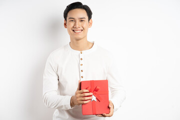 Wall Mural - Asian businessman is holding red gift box on white background