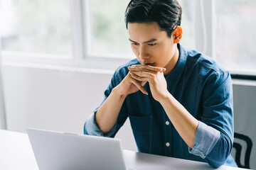 Wall Mural - The Asian man was concentrating on his computer screen