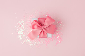 Wall Mural - Gift or present box and stars confetti on pink table top view. Flat lay composition for birthday, mother day, valentine or wedding. Stylish luxury monochrome concept, sale shopping flyer