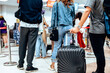 © Charnchai saeheng - people waiting for check in at airport. A man and luggage at the airport terminal.