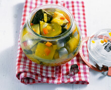 Pickled Courgettes With Turmeric And Mustard Seeds In A Jar
