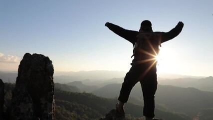 Wall Mural - Success male hiker with arms outstretched on top of mountain