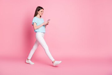 Poster - Full size profile side photo of positive girl use smartphone go copyspace isolated over pastel color background